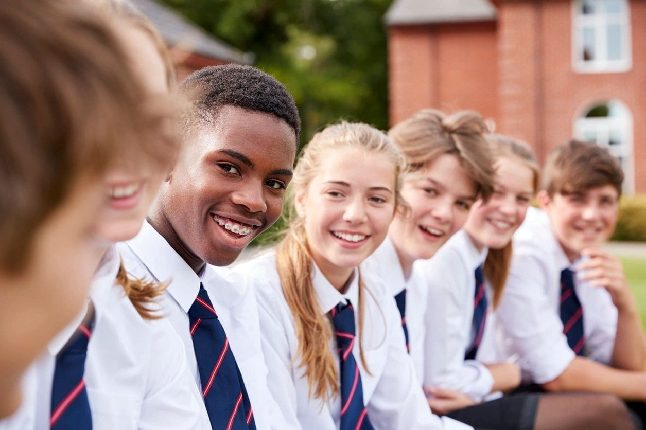 A group of young people in school uniforms.