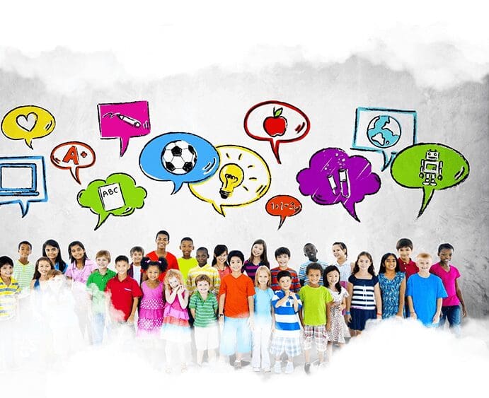 A group of children standing in front of a wall with speech bubbles.