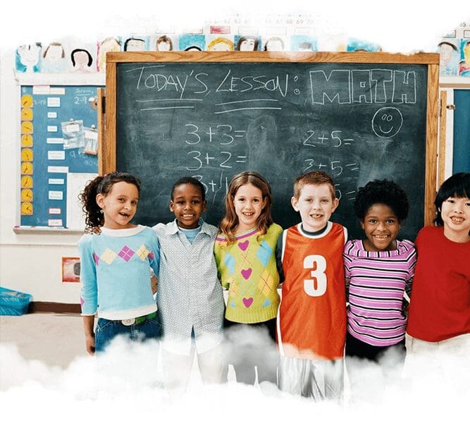 A group of children standing in front of a chalkboard.